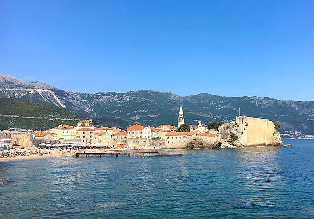 Budva’s old town and its citadel on the promontory, with turquoise sea and mountains
