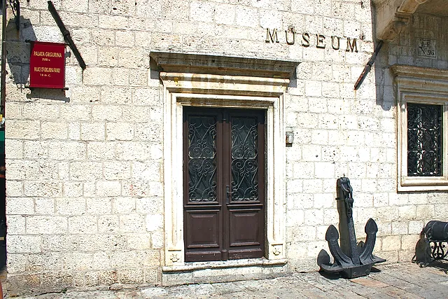 The portal of the Grgurina Palace, home of the Maritime Museum in Kotor, with an anchor beside the door